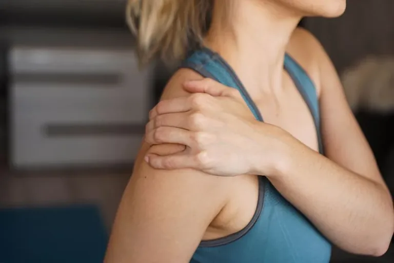 Person holding shoulder in pain - shoulder condition